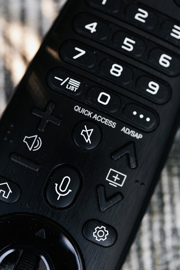 Services Detailed view of a remote control featuring buttons with numbers and symbols, emphasizing usage.